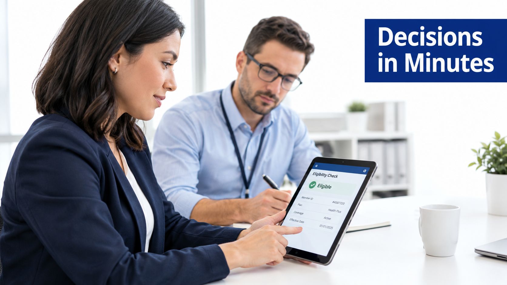 A businesswoman and her male colleague using a digital tablet to review healthcare eligibility status together.